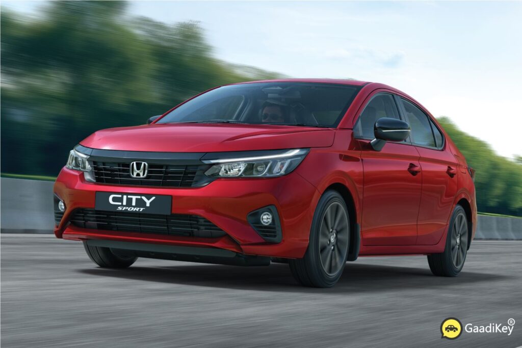2025 Honda City Sport front view in Radiant Red Metallic with black grille and sporty bumper design