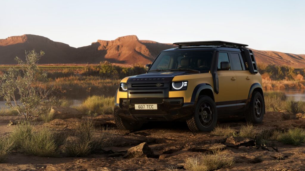 International teams navigating extreme obstacle course with Defender vehicles during Defender Trophy qualifying round, highlighting teamwork and off-road capability