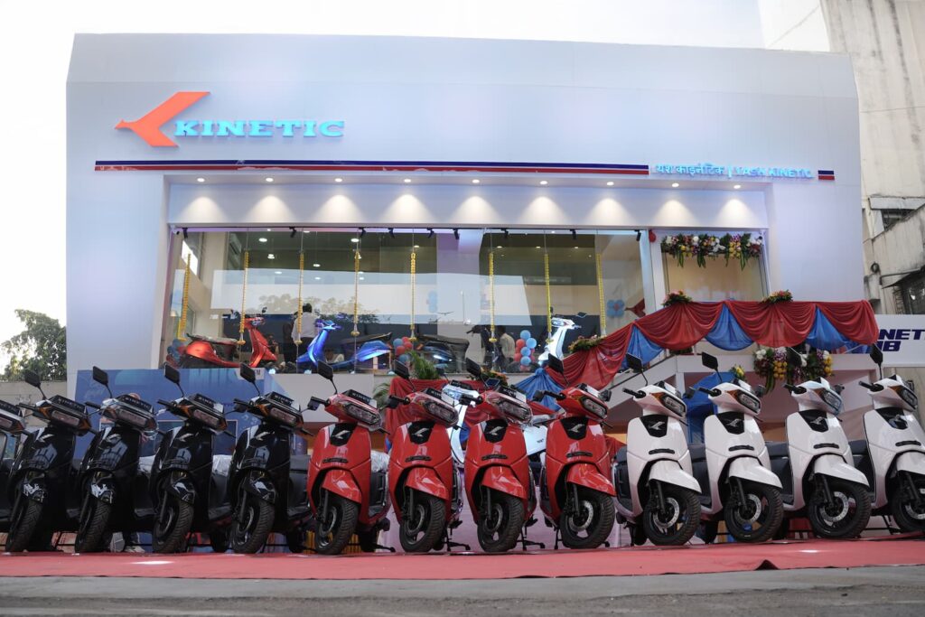 Kinetic DX and Kinetic DX+ Electric Scooters lined up in front of New Kinetic Showroom