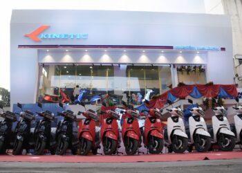 Kinetic DX and Kinetic DX+ Electric Scooters lined up in front of New Kinetic Showroom
